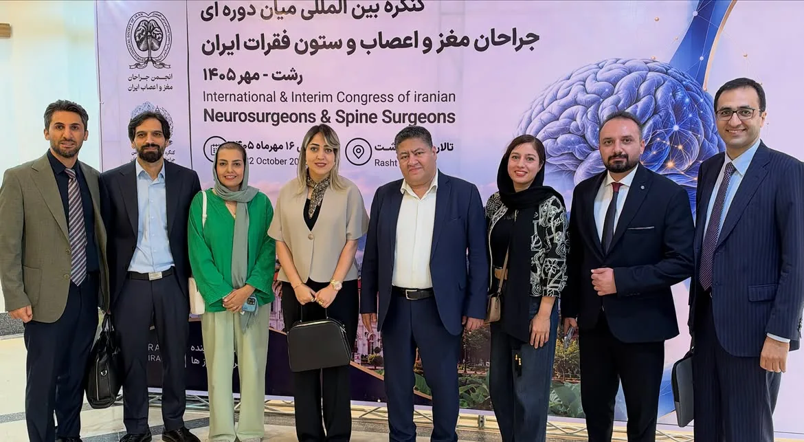 Prof. Guive Sharifi with colleagues in front of the official congress banner in Rasht