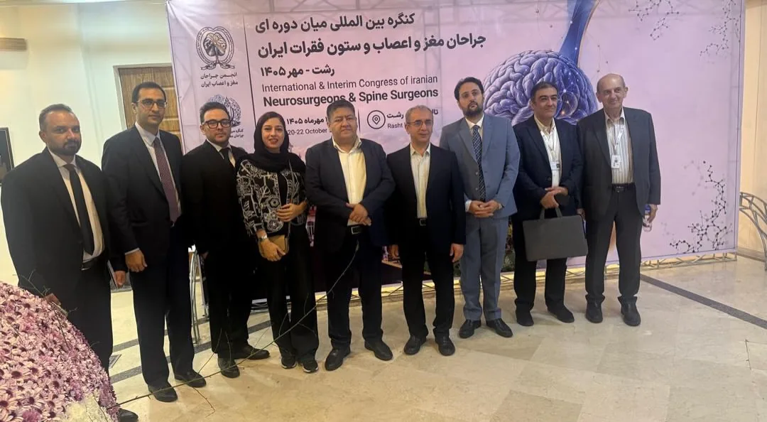 Prof. Guive Sharifi with faculty in front of the Rasht congress banner