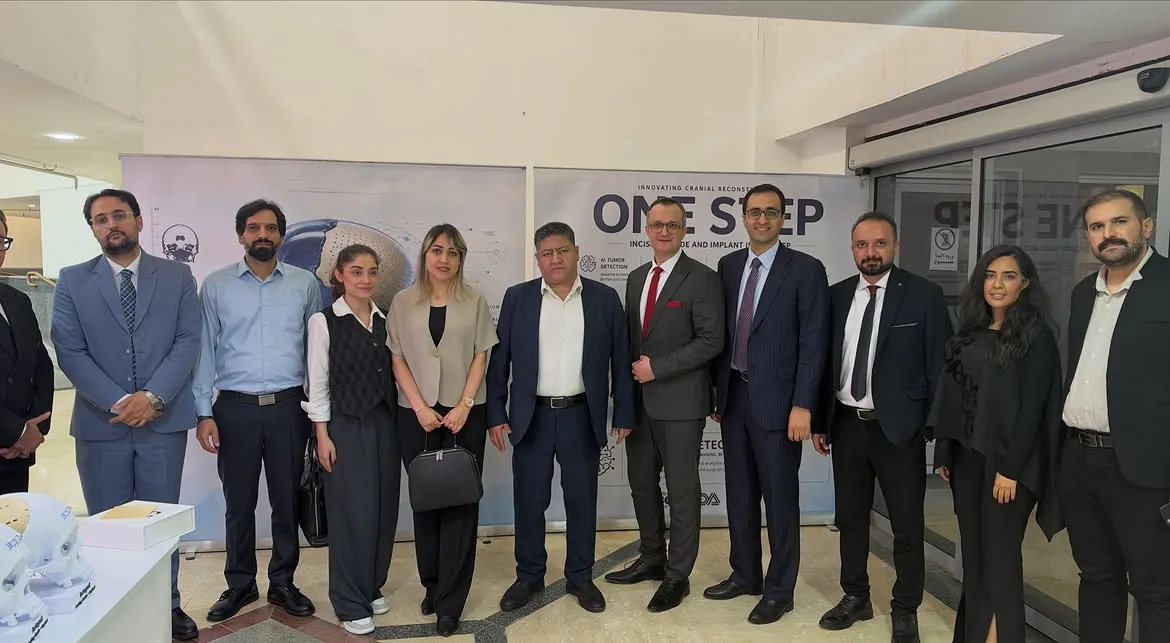 Prof. Guive Sharifi with colleagues at a cranial reconstruction exhibition stand