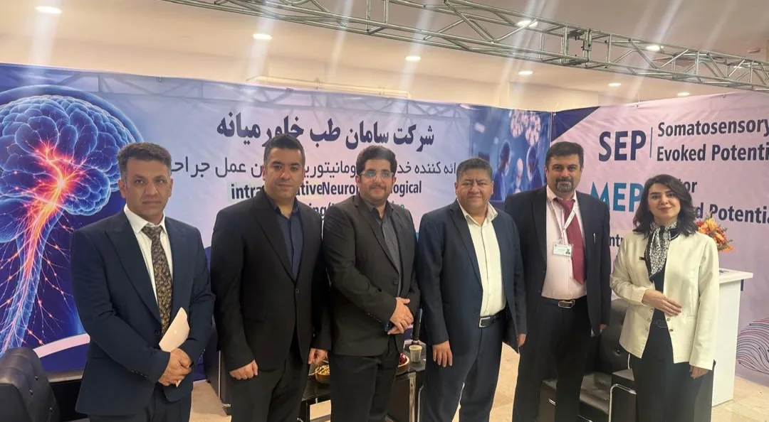 Prof. Guive Sharifi with colleagues at an intraoperative neuromonitoring exhibition booth
