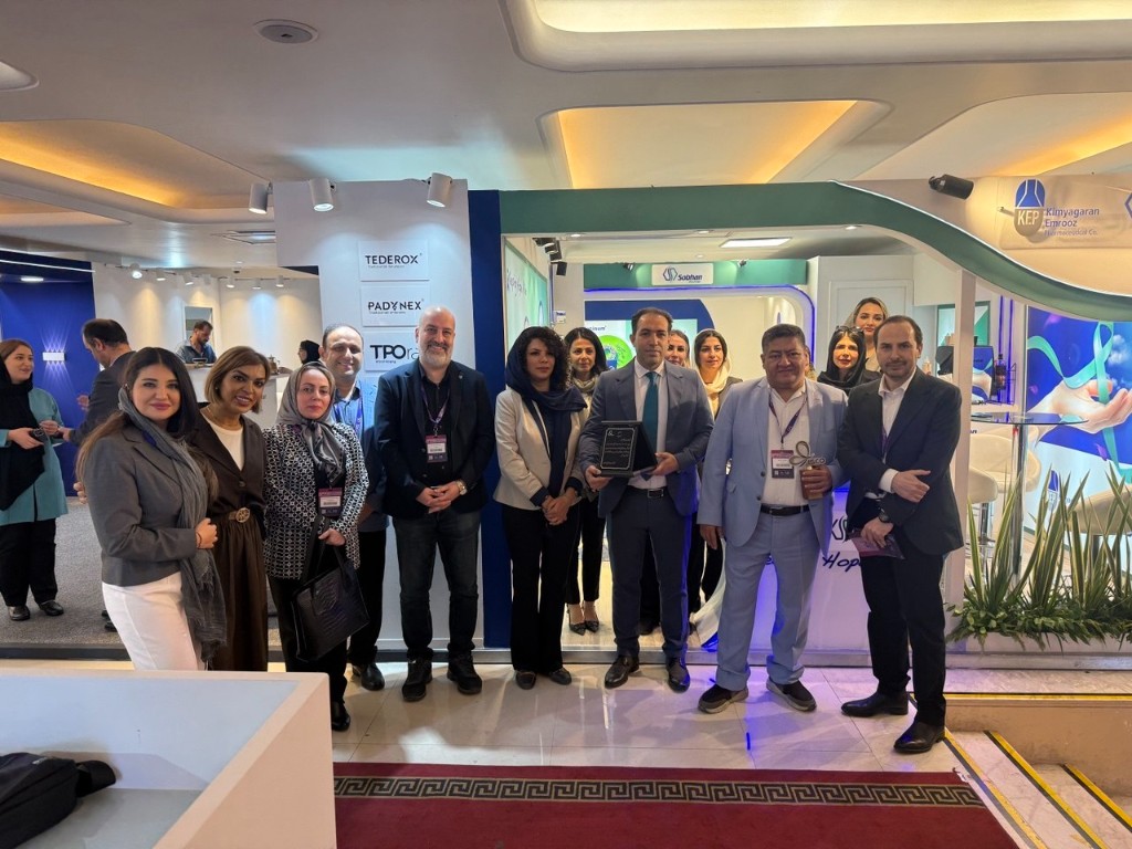 Medical professionals at exhibition booths with awards at the oncology congress