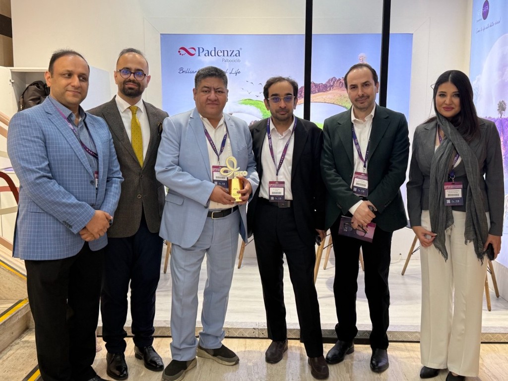 Medical professionals posing at the Padenza Palbociclib exhibition booth