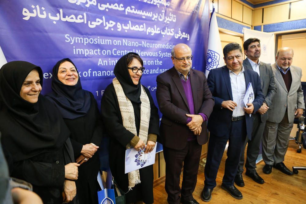 Organizers and speakers posing with symposium materials